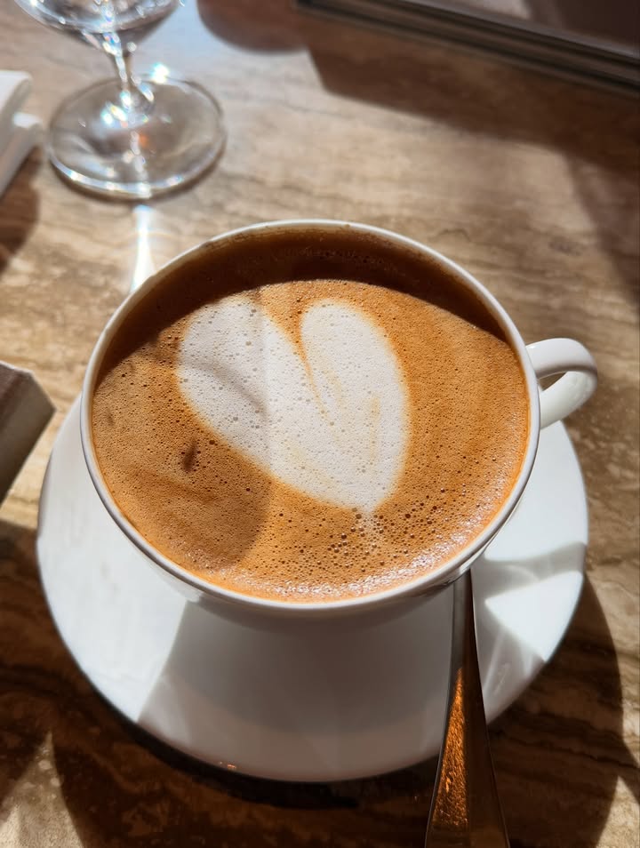 May be an image of coffee, coffee cup, saucer, cappuccino and text