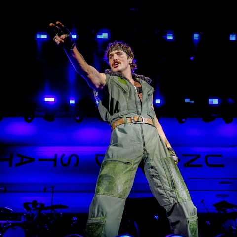 May be an image of tambourine, jumpsuit, concert and text