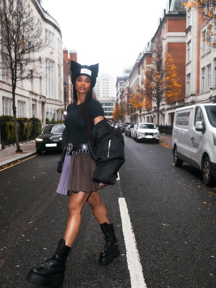 May be an image of boots, beret, fishnet stockings, headscarf, kilt, miniskirt, street and text