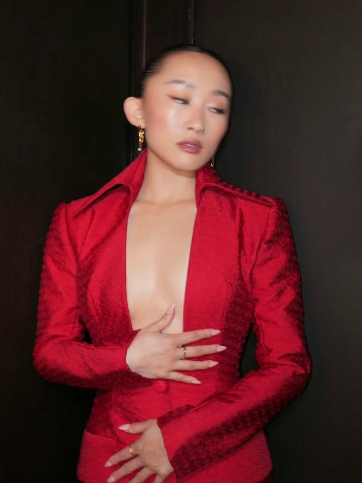 May be an image of suit, blazer and text