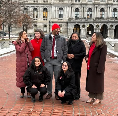 May be an image of standing, office and text