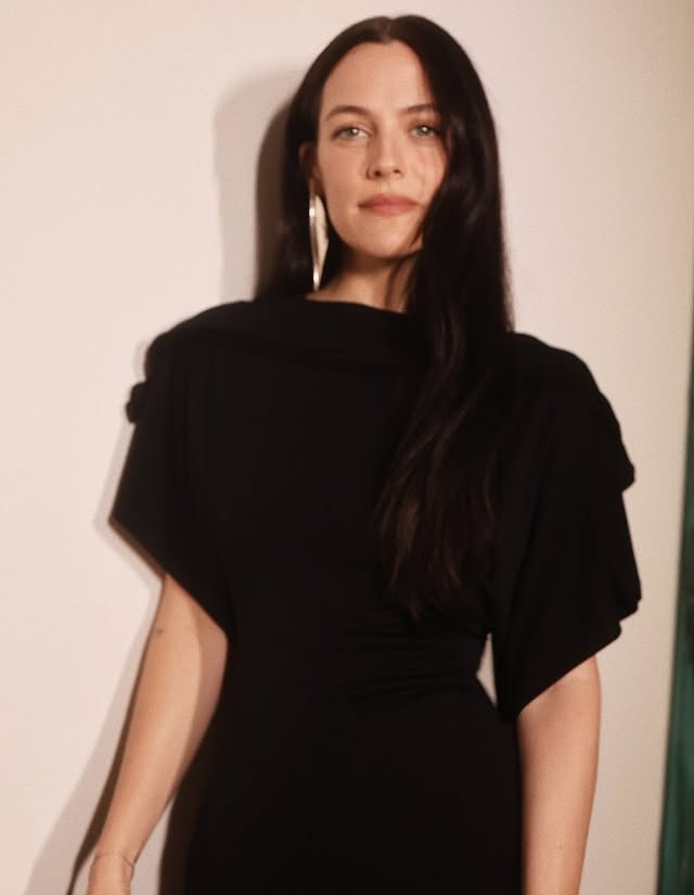 May be an image of turtleneck, dress and text