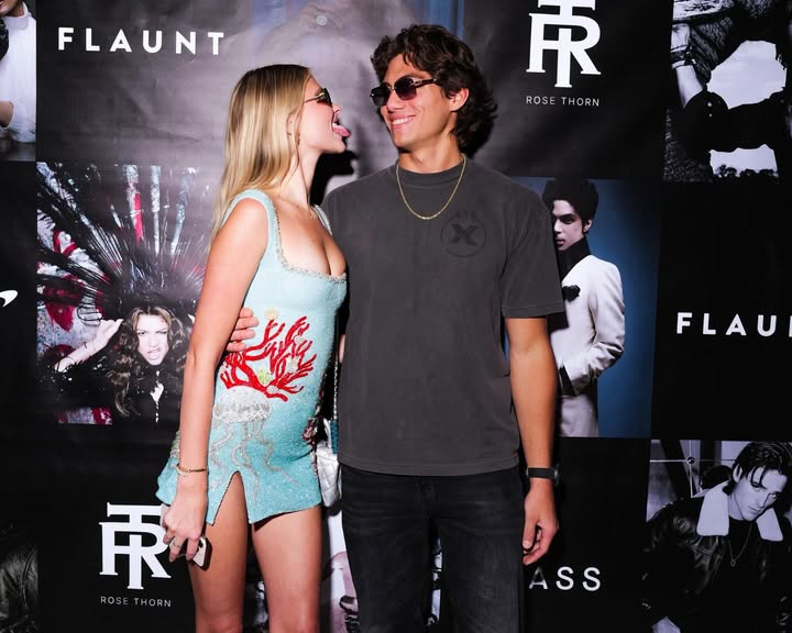 May be an image of ‎standing, eyewear and ‎text that says '‎FLAUNT 乐 ROSETHORN ROSE THORN د FLAU 東 ROSETHORN ROSB THORN ASS‎'‎‎