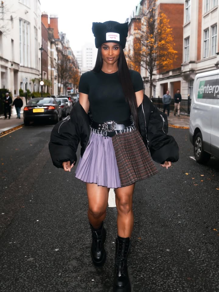 May be an image of boots, beret, kilt, miniskirt, headscarf and text