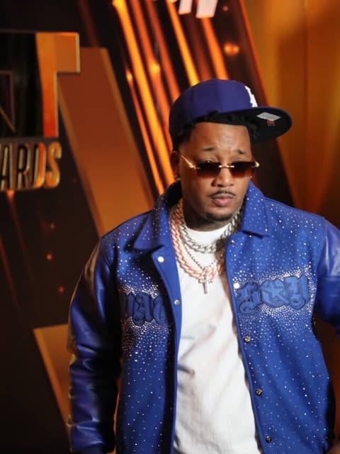 May be an image of one or more people, jacket and text