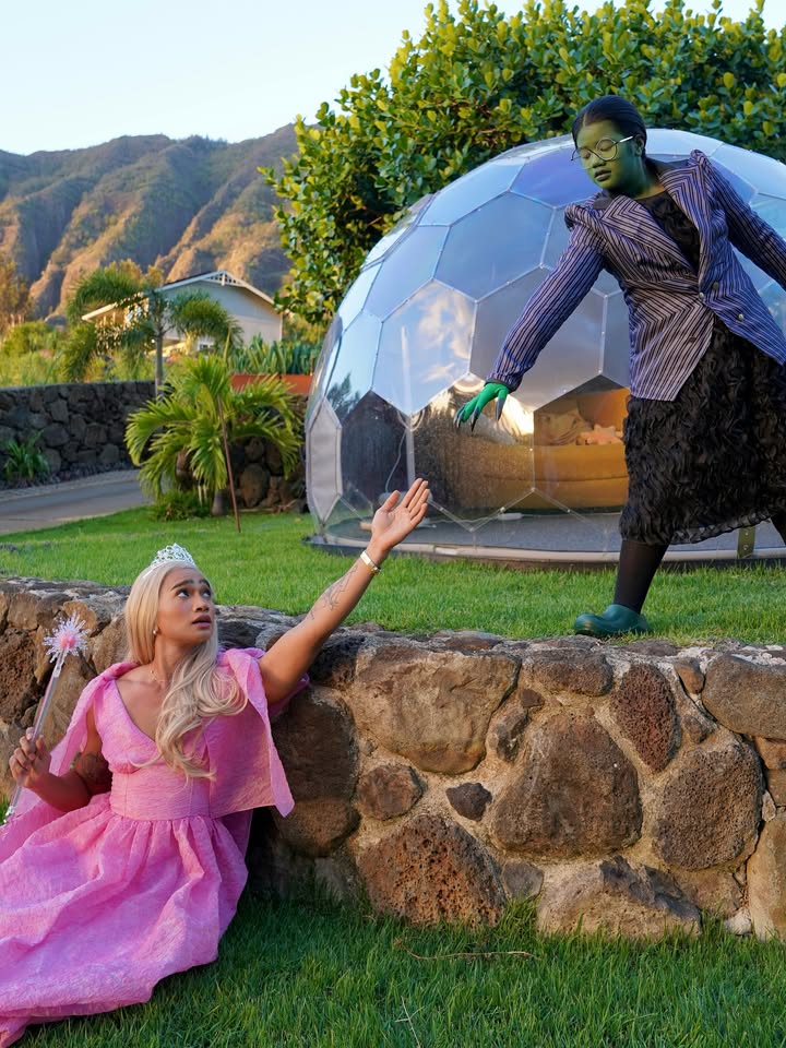 May be an image of headdress, parasol and glasses