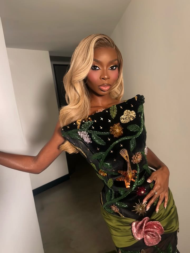 May be an image of one or more people, makeup, gown, dress and text