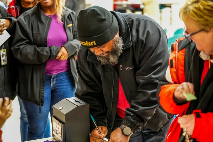 May be an image of one or more people, people standing, phone, portable cassette player, crowd and text