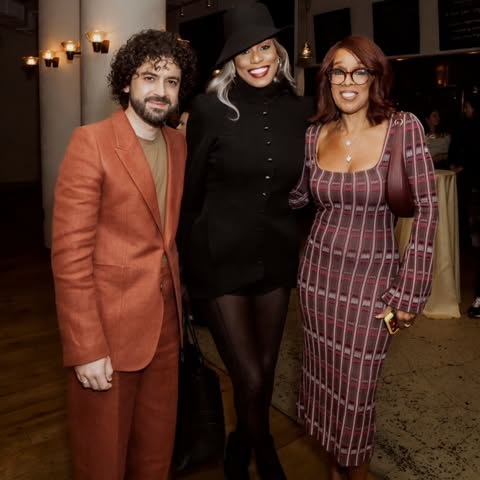 May be an image of one or more people, makeup, people standing, suit, blazer and text