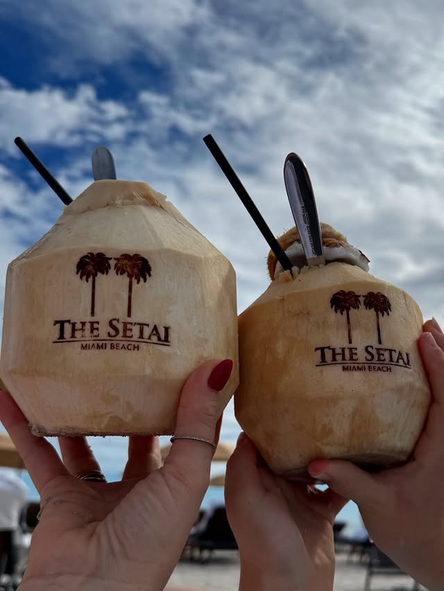 May be an image of coconut, drink and text