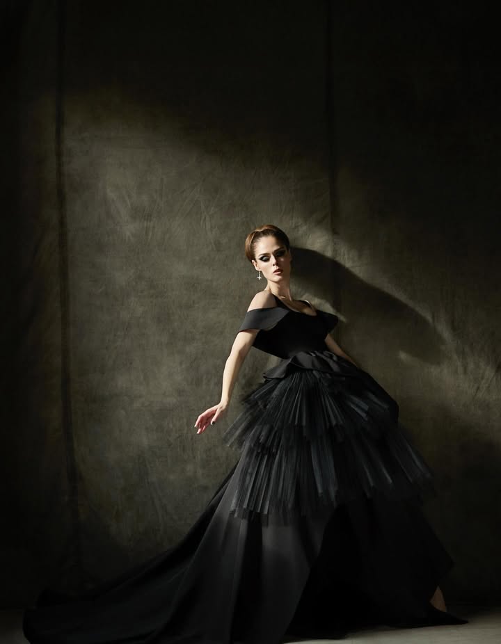 May be an image of dress, costume, gown and text