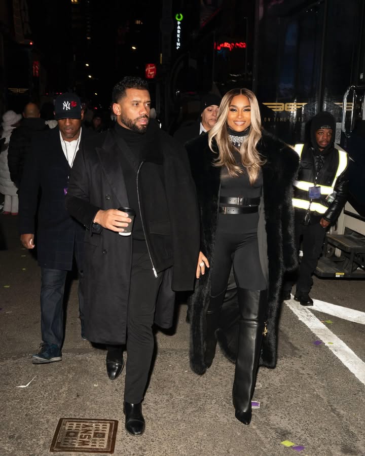 May be an image of one or more people, makeup, people standing, overcoat and text