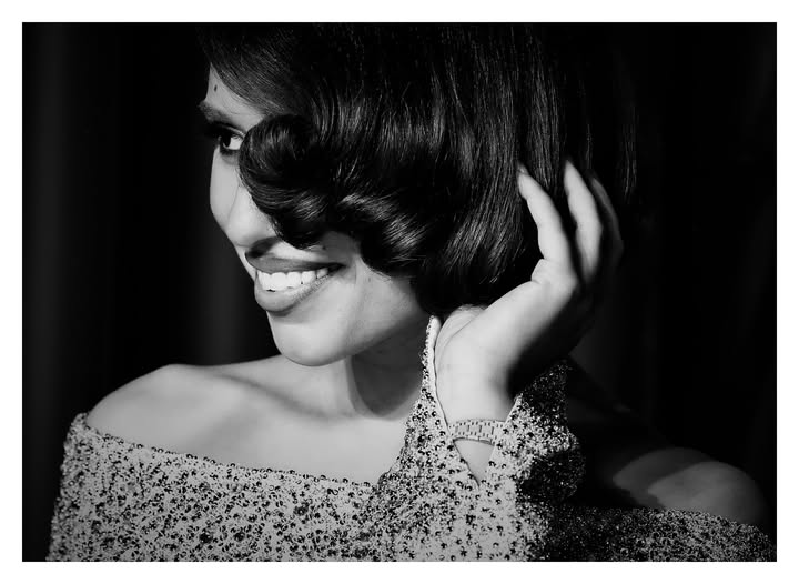 May be a black-and-white image of one or more people, makeup, hair, people smiling and text