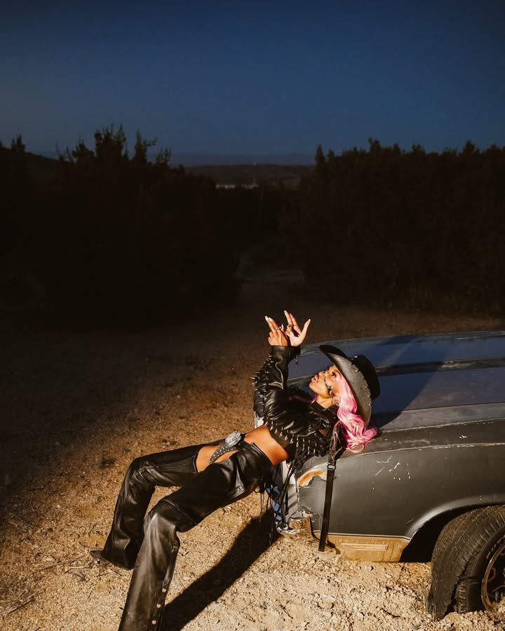 May be an image of bandanna, headscarf and text