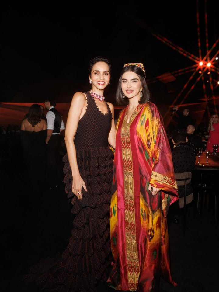 May be an image of one or more people, dress, headdress and text