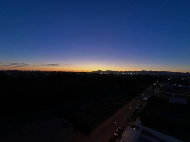 May be an image of horizon, twilight, sky and text