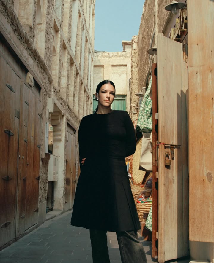 May be an image of one or more people, makeup, overcoat, turtleneck and text