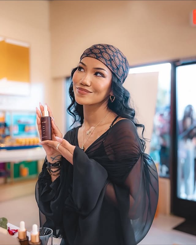 May be an image of one or more people, makeup, hand cream, cosmetics, headscarf, turban, head covering and text