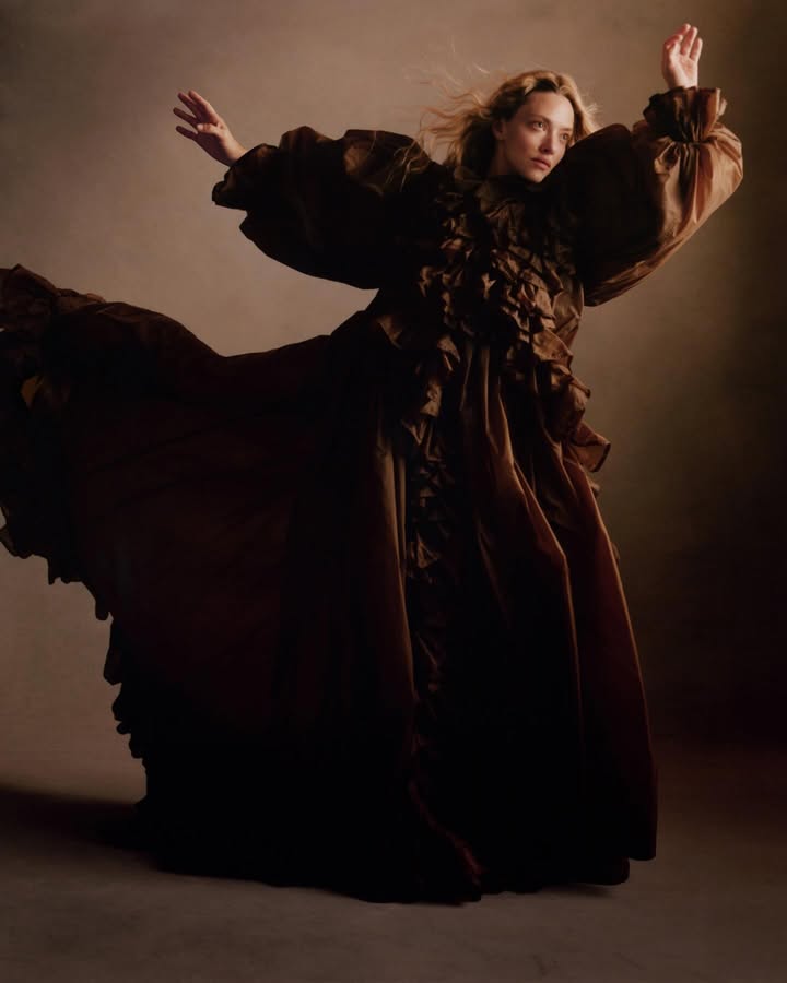 May be an image of gown, costume, cloak and text