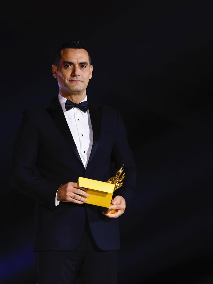 May be an image of one or more people, suit, dinner jacket and text