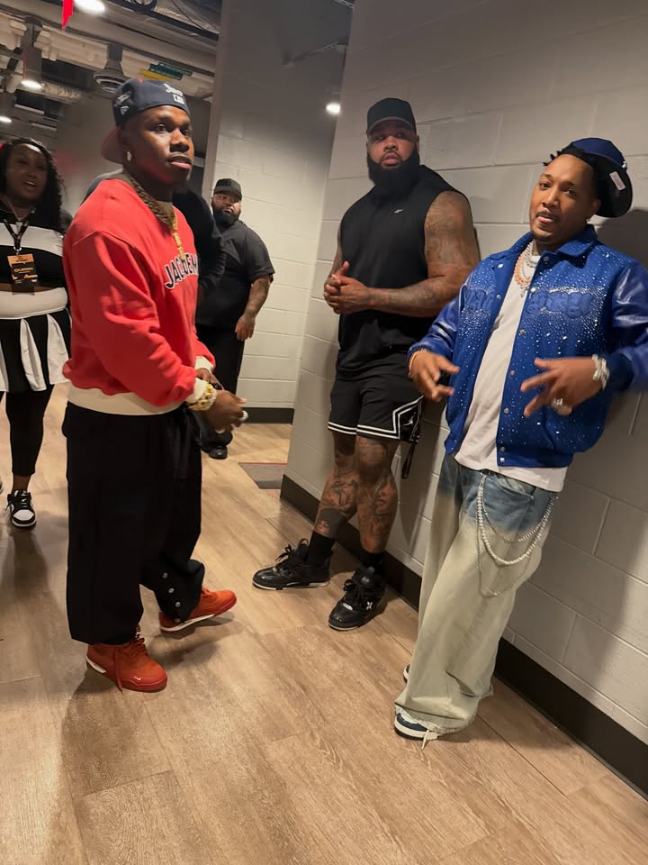 May be an image of one or more people, people standing, sweatsuit and text