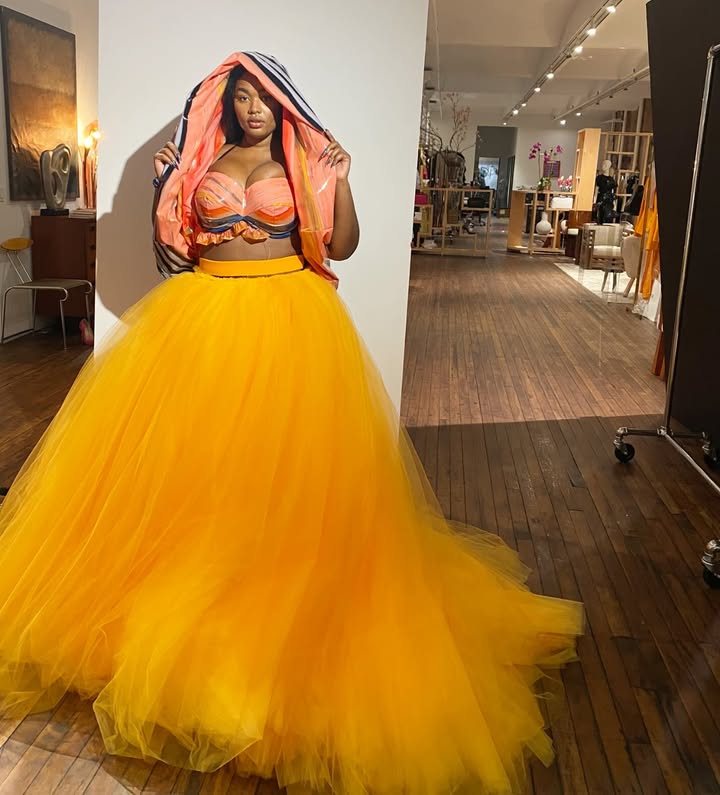 May be an image of dress, skirt, gown and text