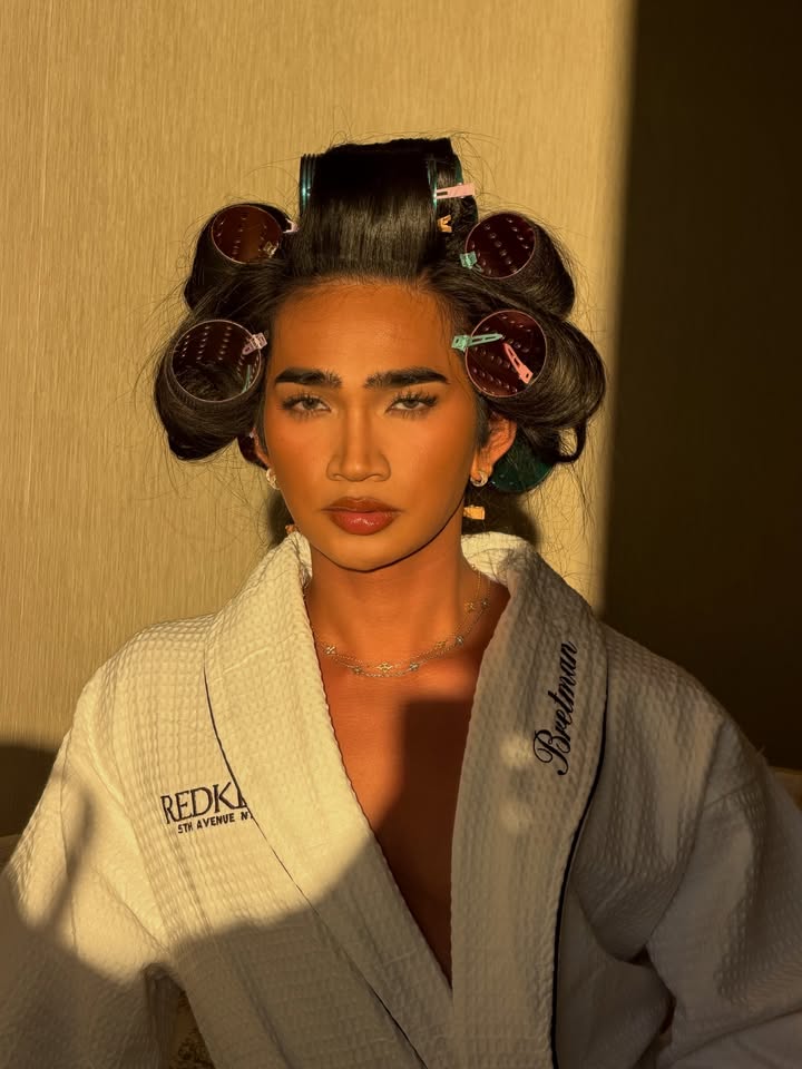 May be an image of one or more people, hair, makeup, robe, bath robe and text