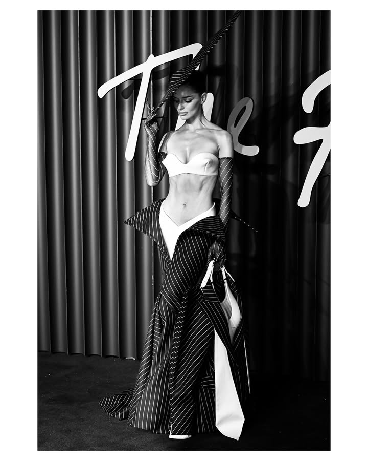 May be a black-and-white image of one or more people, makeup, headscarf and text