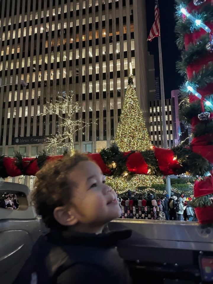 May be an image of baby, standing, christmas tree, tinsel and text