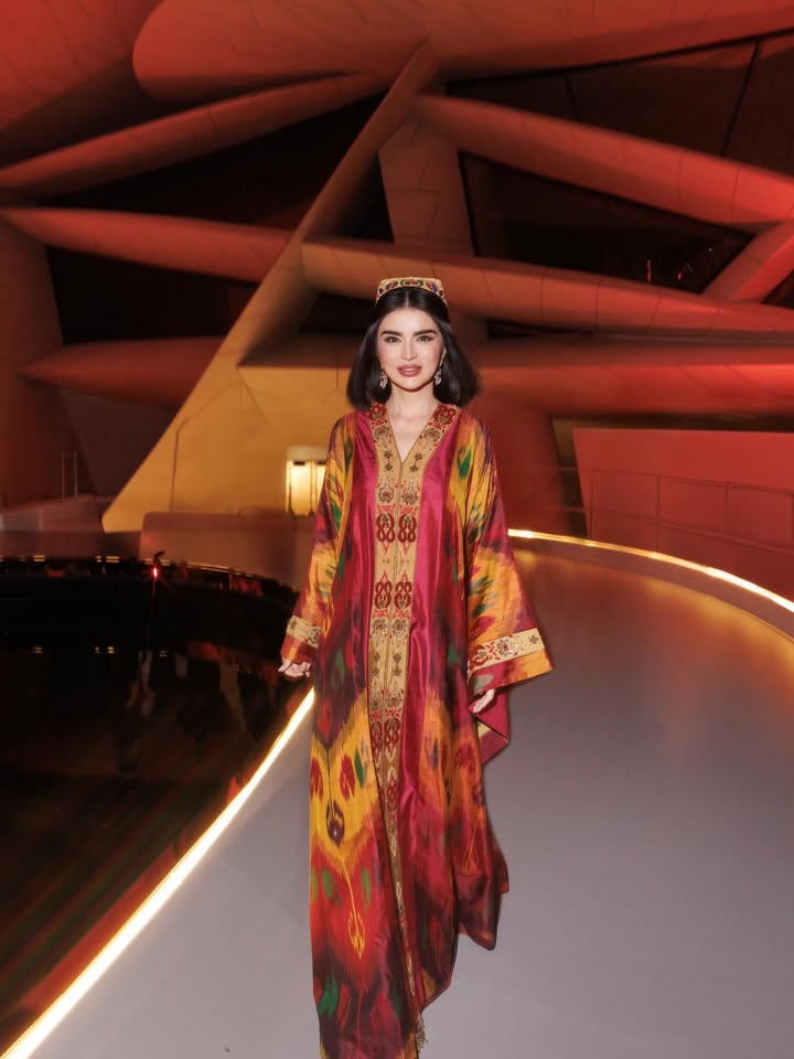 May be an image of dress, headdress and text