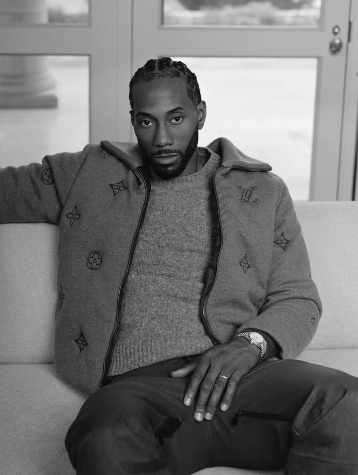 May be a black-and-white image of one or more people, beard, overcoat, suit, duffle coat, turtleneck, blazer and text