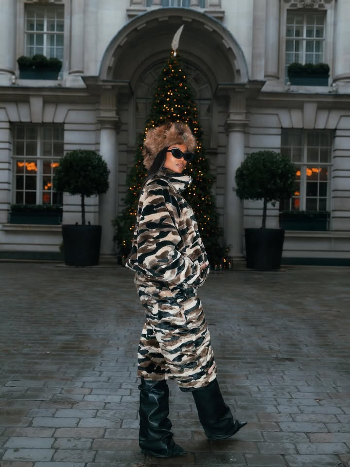 May be an image of overcoat, christmas tree, tinsel, parka, military uniform, beret, turtleneck and text