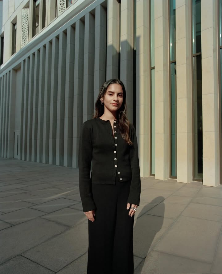 May be an image of turtleneck, suit and text