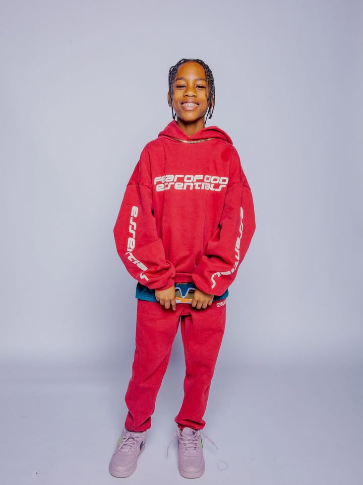 May be an image of child, sweatpants, sweater, sportswear, fleece, sweatshirt, sweatsuit and text