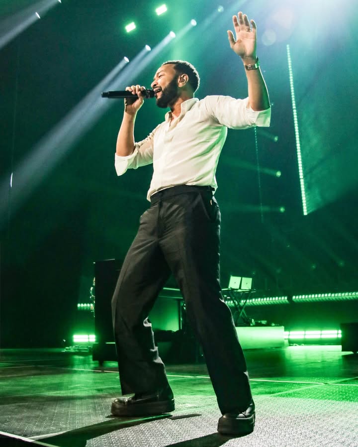 May be an image of one or more people, microphone, concert and text