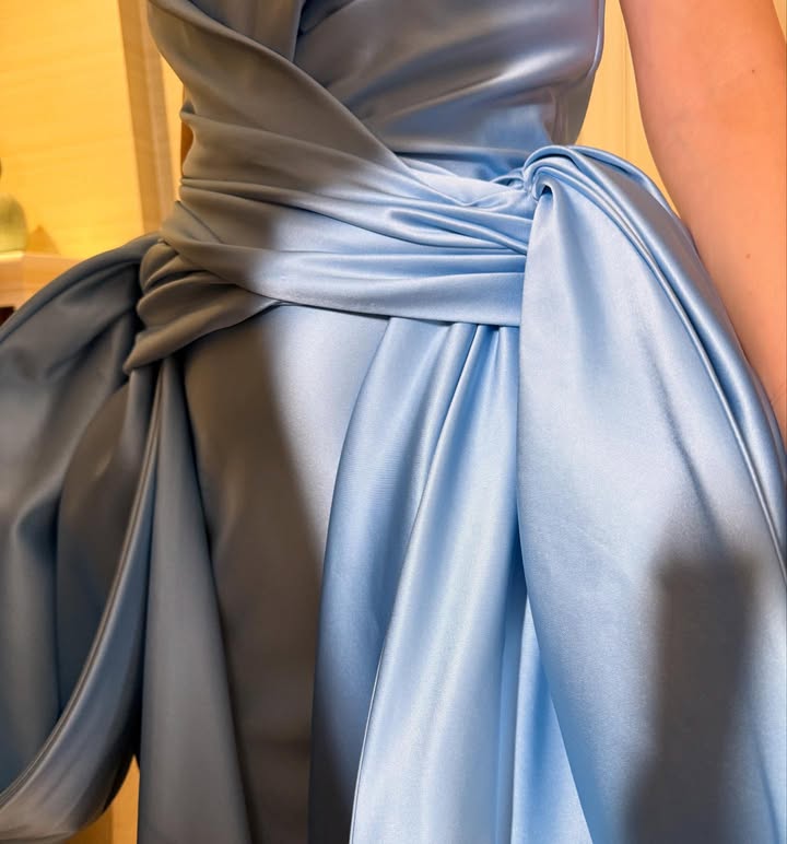 May be an image of gown and text