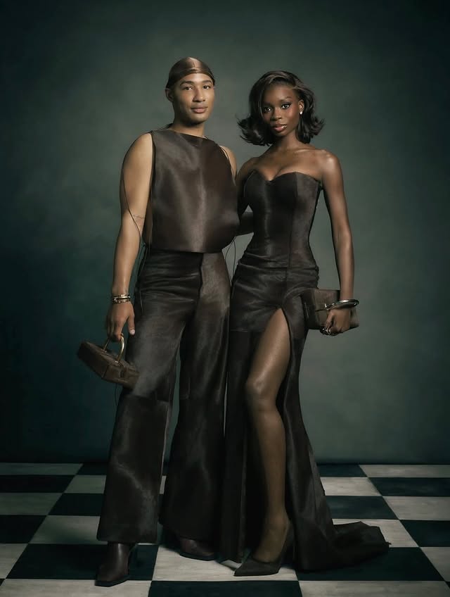 May be an image of one or more people, makeup, leather, glasses, dress, gown and text