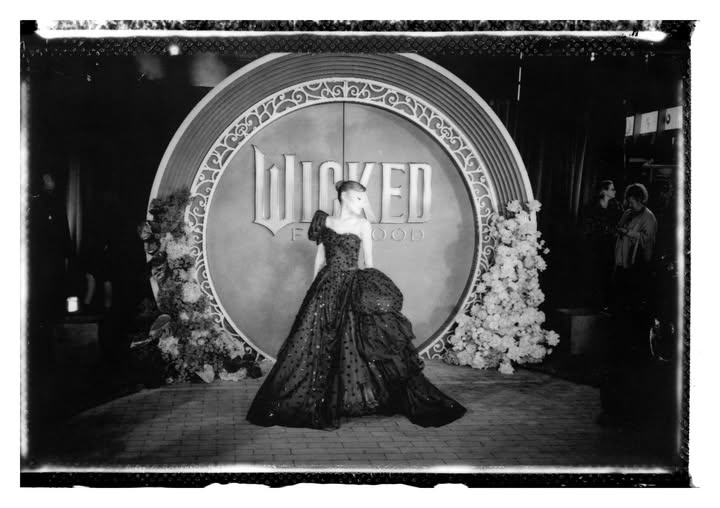 May be a black-and-white image of one or more people, costume, gown and text