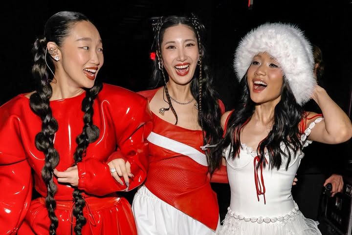 May be an image of one or more people, braids, people dancing, costume, dress and text