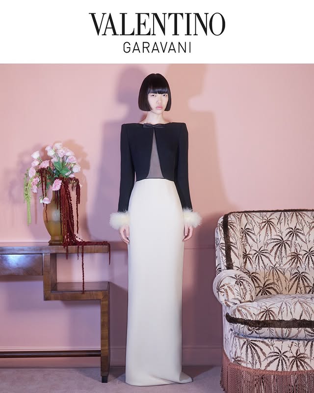 May be an image of gown and text