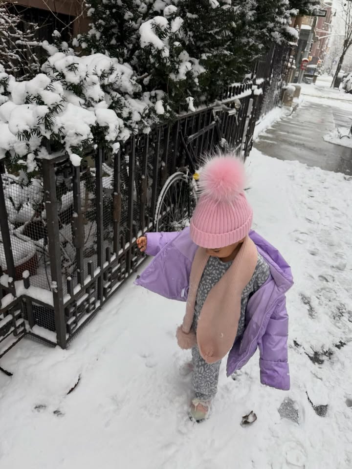 May be an image of snowball, snowsuit, parka, snow and text