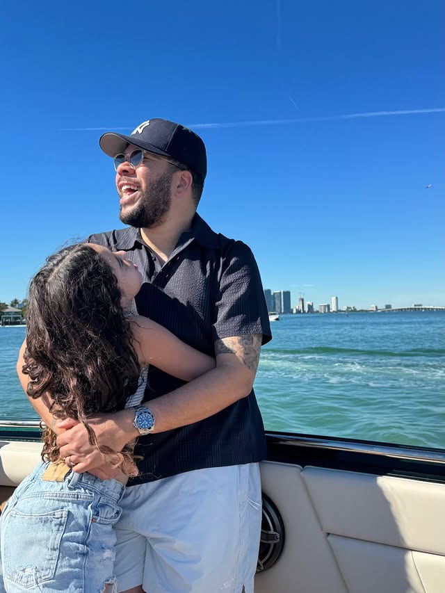 May be an image of smiling, people kissing, boat, yacht and text