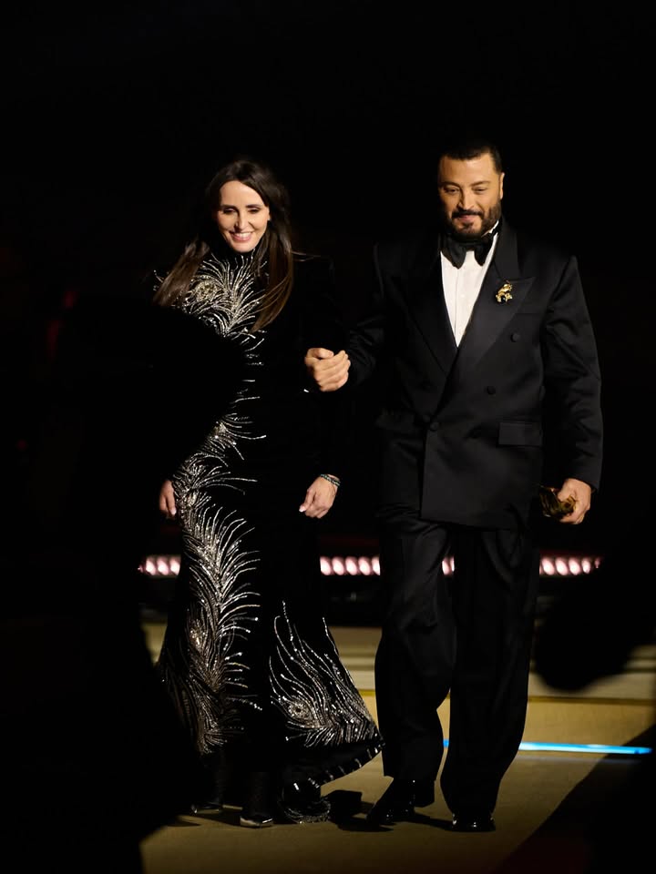 May be an image of dress, dinner jacket, gown and text