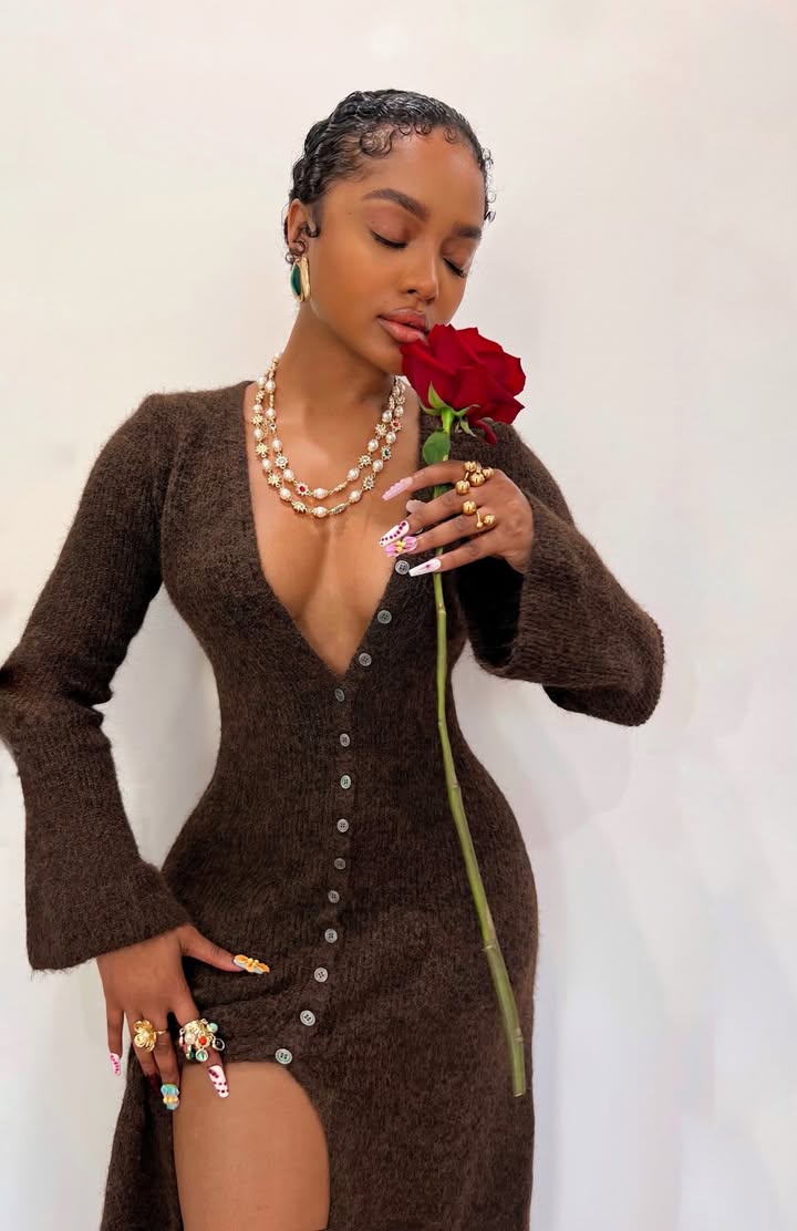 May be an image of one or more people, gown, dress, rose and text