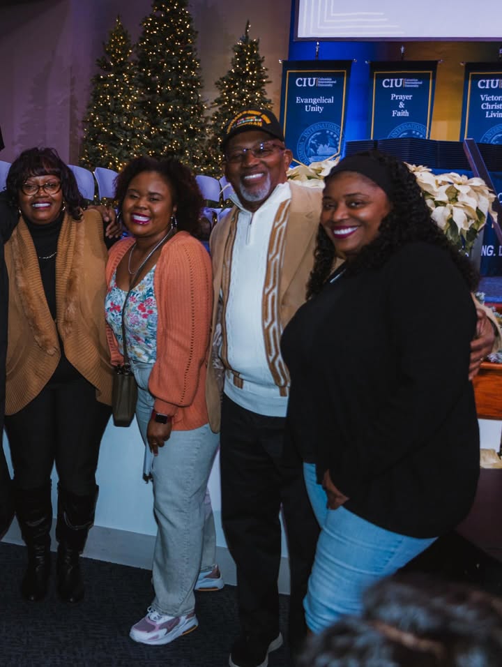 May be an image of one or more people, people smiling, people standing, sweater, night and text that says 'CIU Evangelical Unity CIUI 手 Prayer & Faith Faith CIU Vietor Christ Livin NG.'