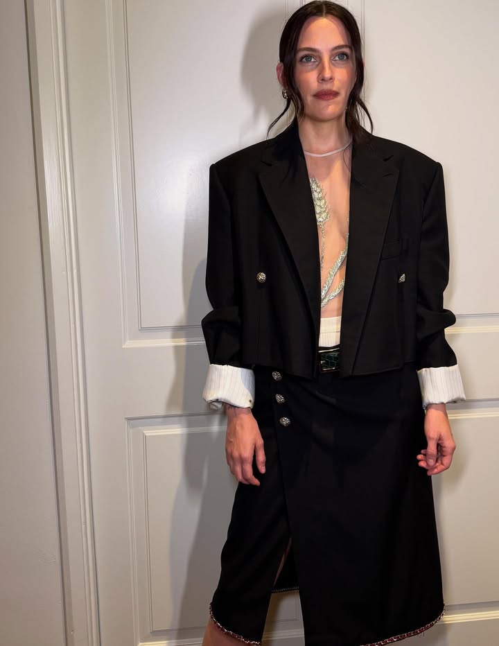 May be an image of blazer, suit and text