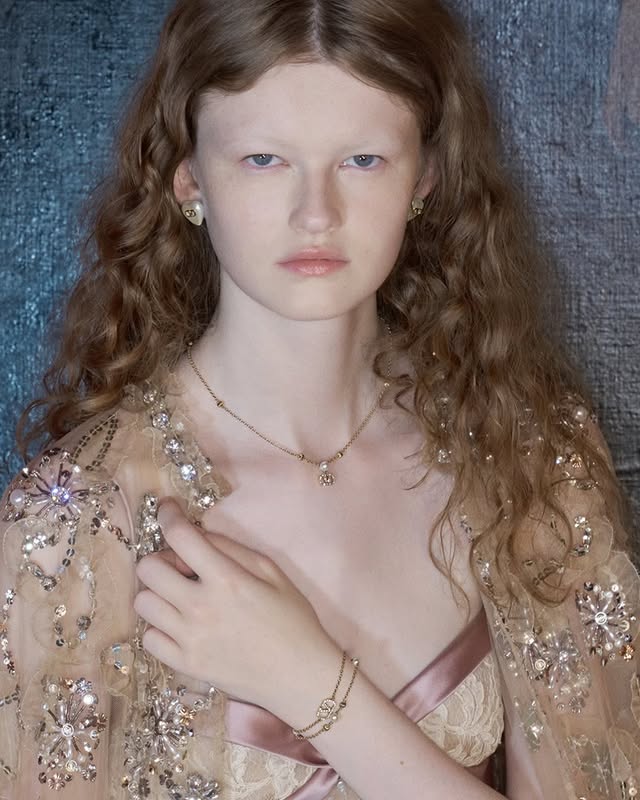 May be an image of one or more people, makeup, jewelry and text