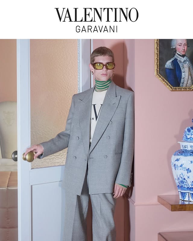 May be an image of suit and text