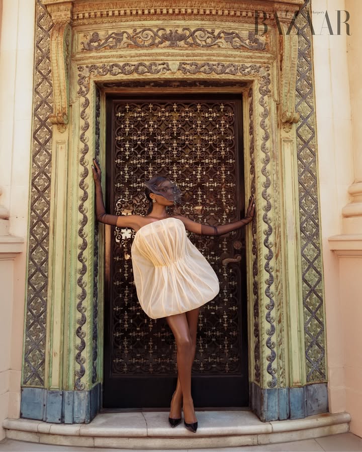 May be an image of dress, headscarf, bowler hat, door and text