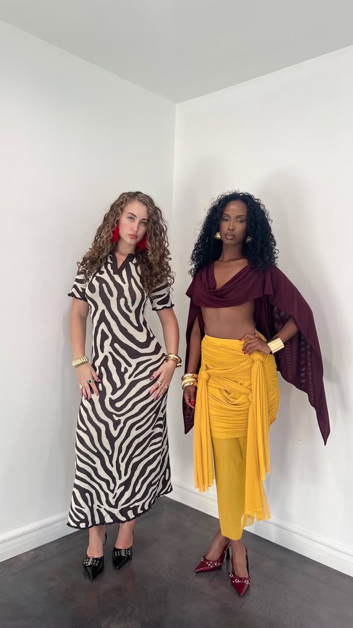 May be an image of one or more people, poncho, skirt and text